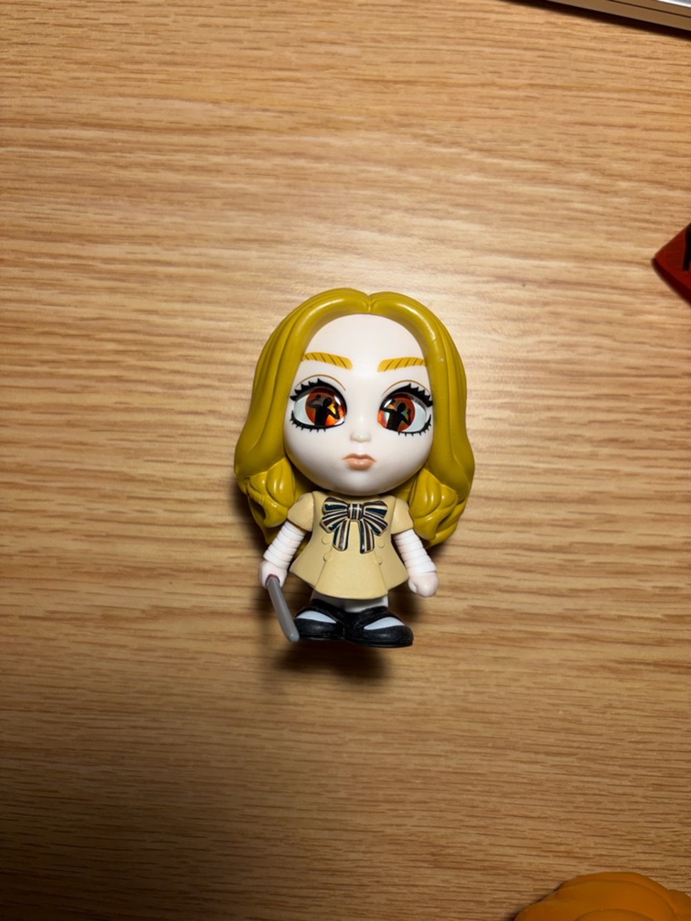 Yellow-Haired Doll Figurine with Bow Detail